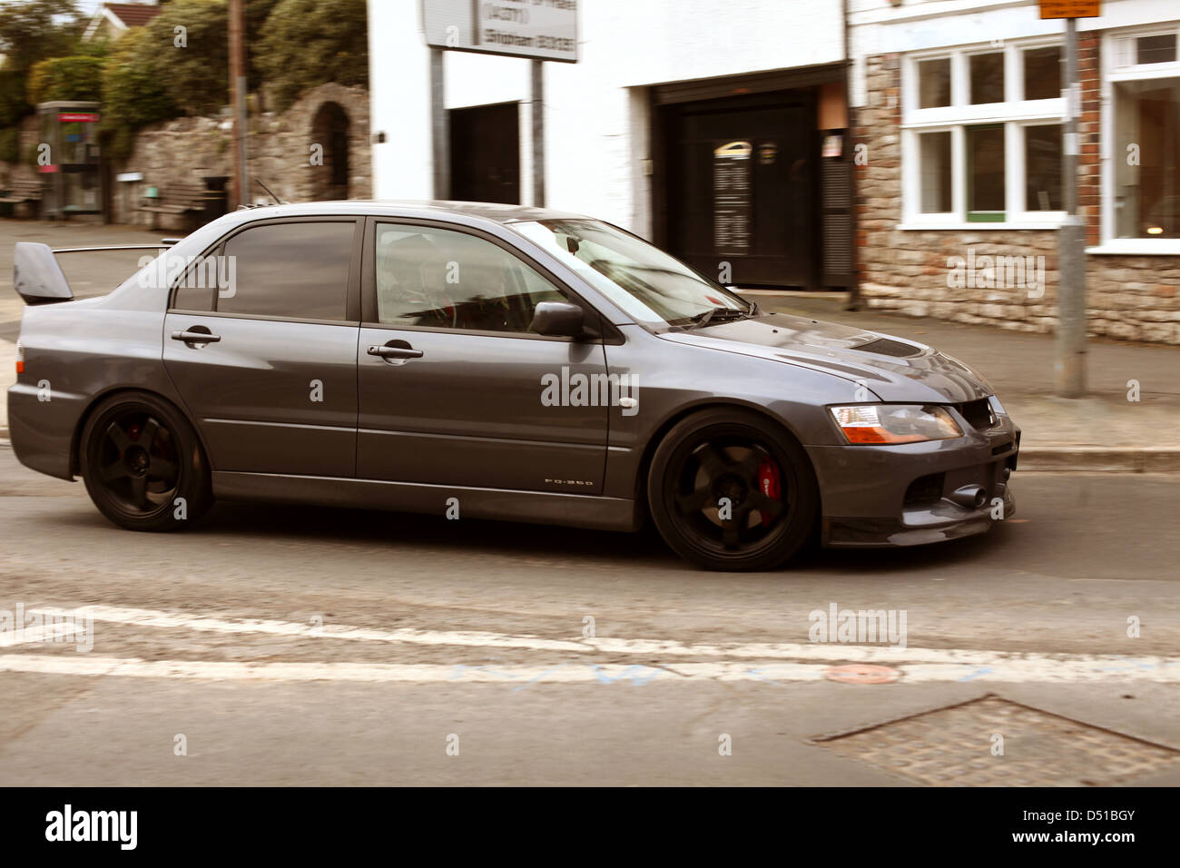 Mitsubishi  EVO in the village of Cheddar, in Somerset. At the base of the gorge getting ready to drive up the gorge Stock Photo