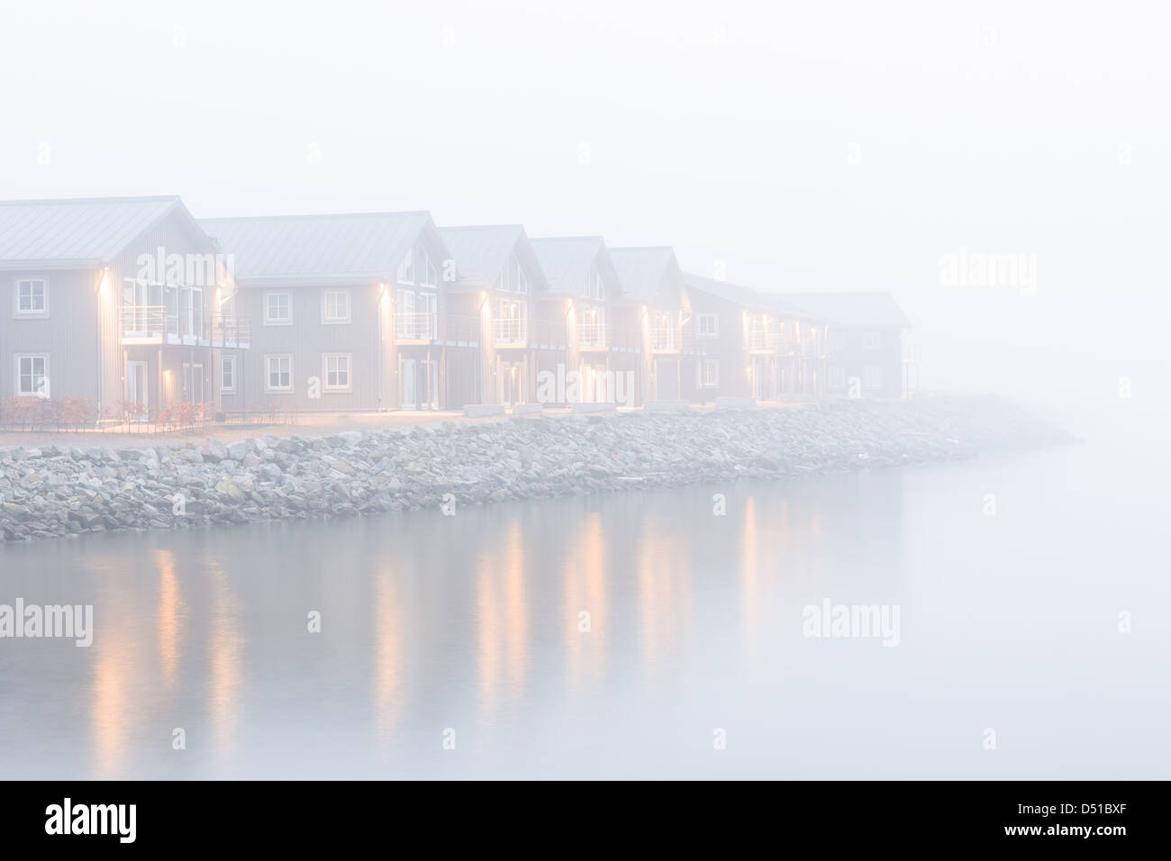 Morning mist over lakeside buildings, Nya Varvet, Gothenburg, Sweden, Europe Stock Photo