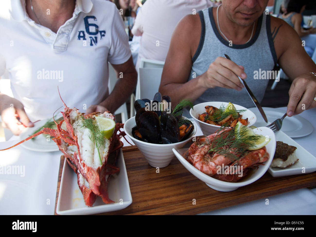People enjoying a seafood platter at restaurant in Waterfront , Cape