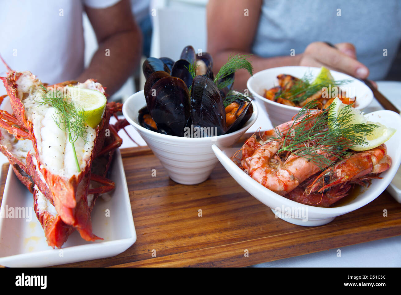 People enjoying a seafood platter at restaurant in Waterfront , Cape Town South Africa Stock