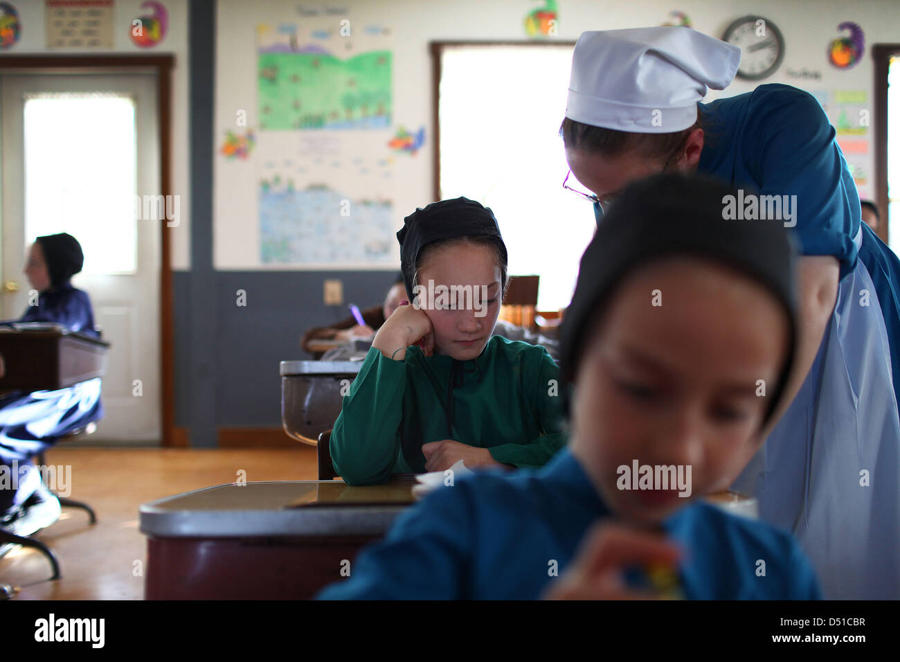 Dec 05, 2012 Bergholz, Ohio, U.S. An Amish girl gets help with her arithmetic lesson at