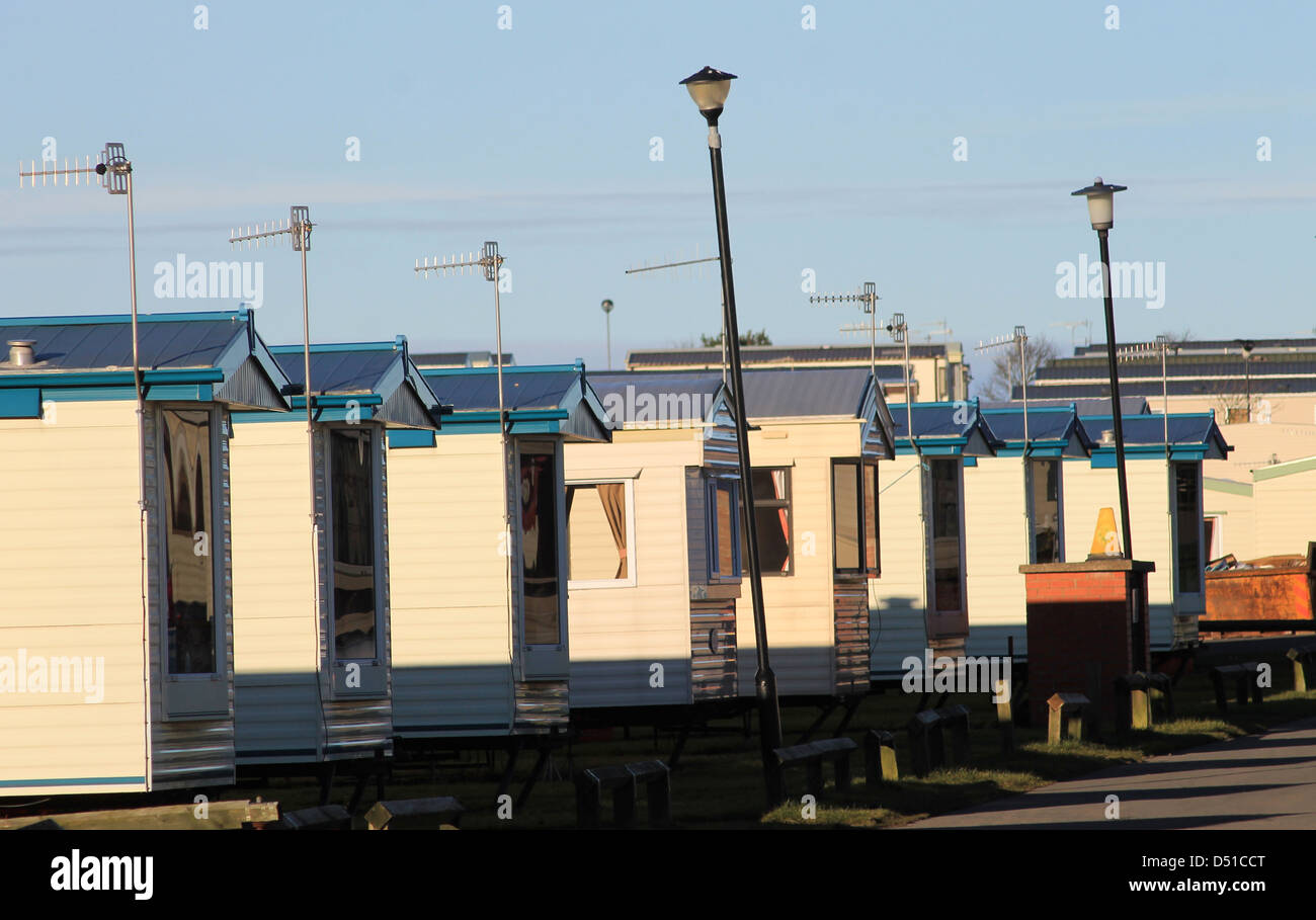Row of caravans in trailer park at sunset. Stock Photo