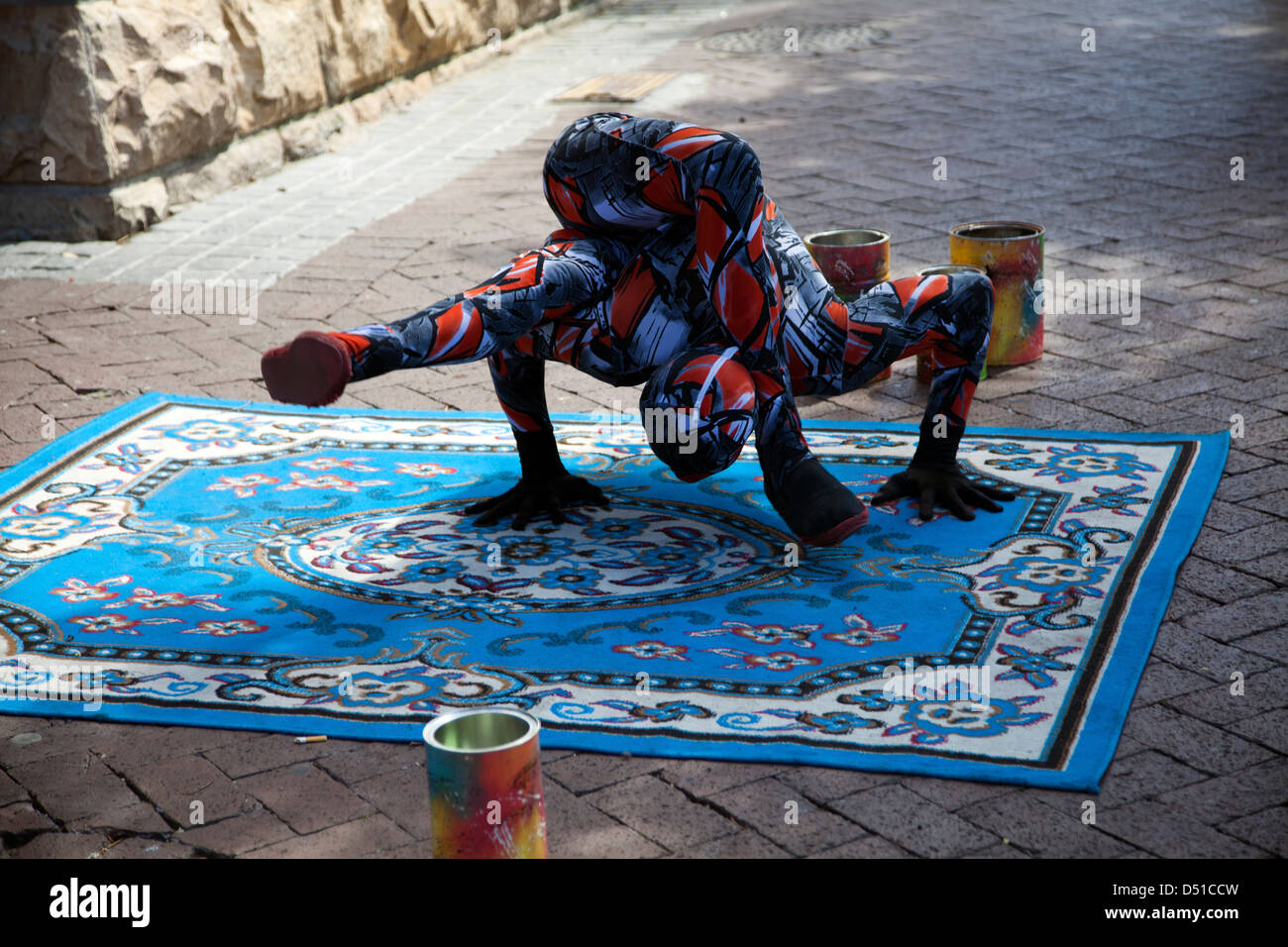 Male Contortionist in Zentai Suits Performs at Waterfront in Cape Town for money - South Africa Stock Photo