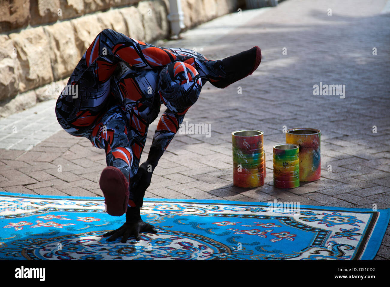 Male Contortionist in Zentai Suits Performs at Waterfront in Cape Town for money - South Africa Stock Photo