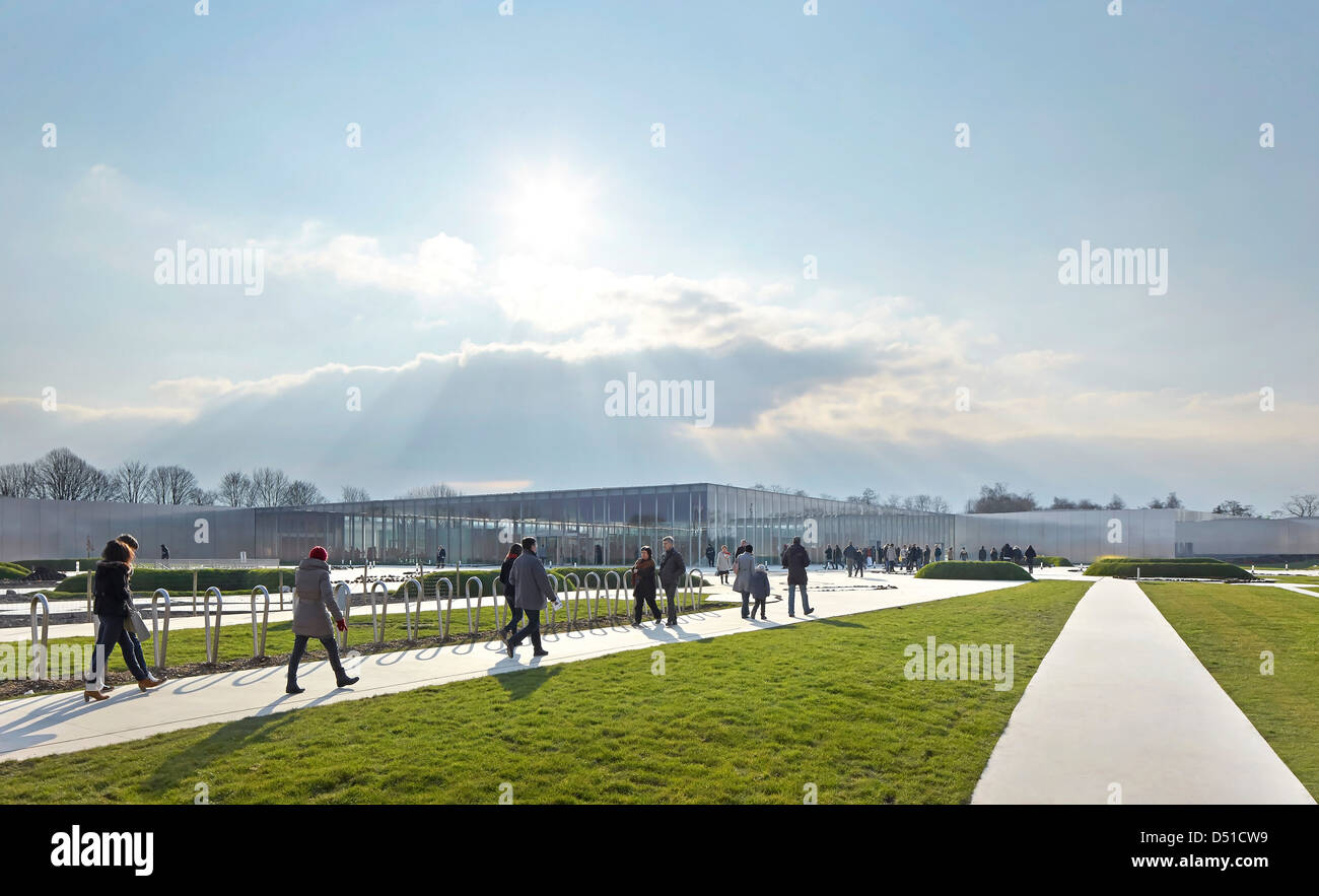 Musée Du Louvre  Lens, Lens, France. Architect: SANAA, 2012. Distant view with landscaped paths and visitors. Stock Photo