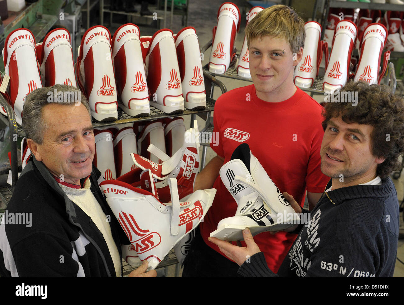 With the ski jumping boot model 'Jump One', Volkmar Rass (L), his grandson  Steve (M) and his son Tom stand at the workshop of the company Rass Special  Sport Shoes manufacturers in