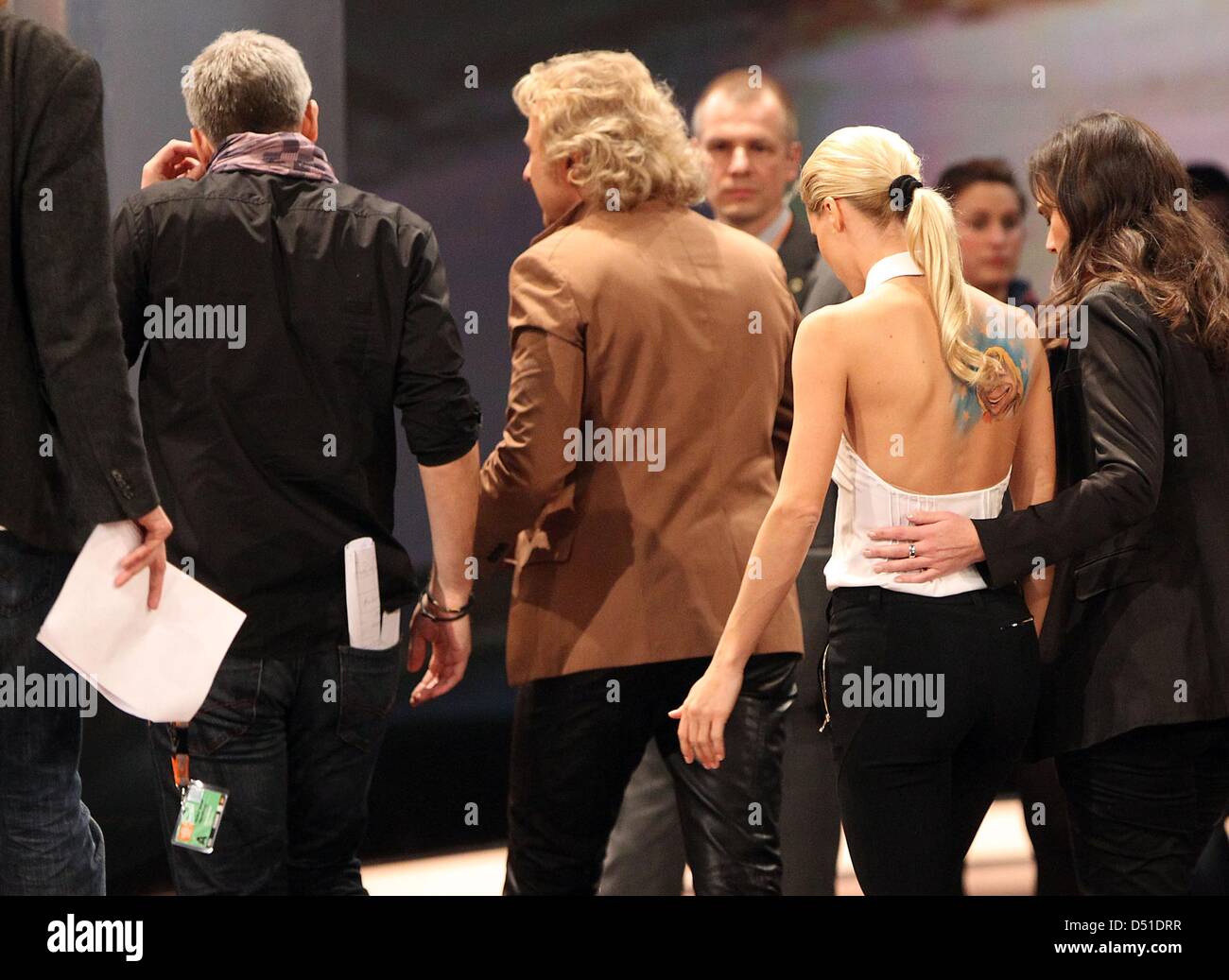 TV moderators Thomas Gottschalk and Michelle Hunziker leave the "Wetten,  dass...?" stage after an accident during the show in Duesseldorf, Germany,  4 December 2010. Bet candidate Samuel Koch had tried to jump