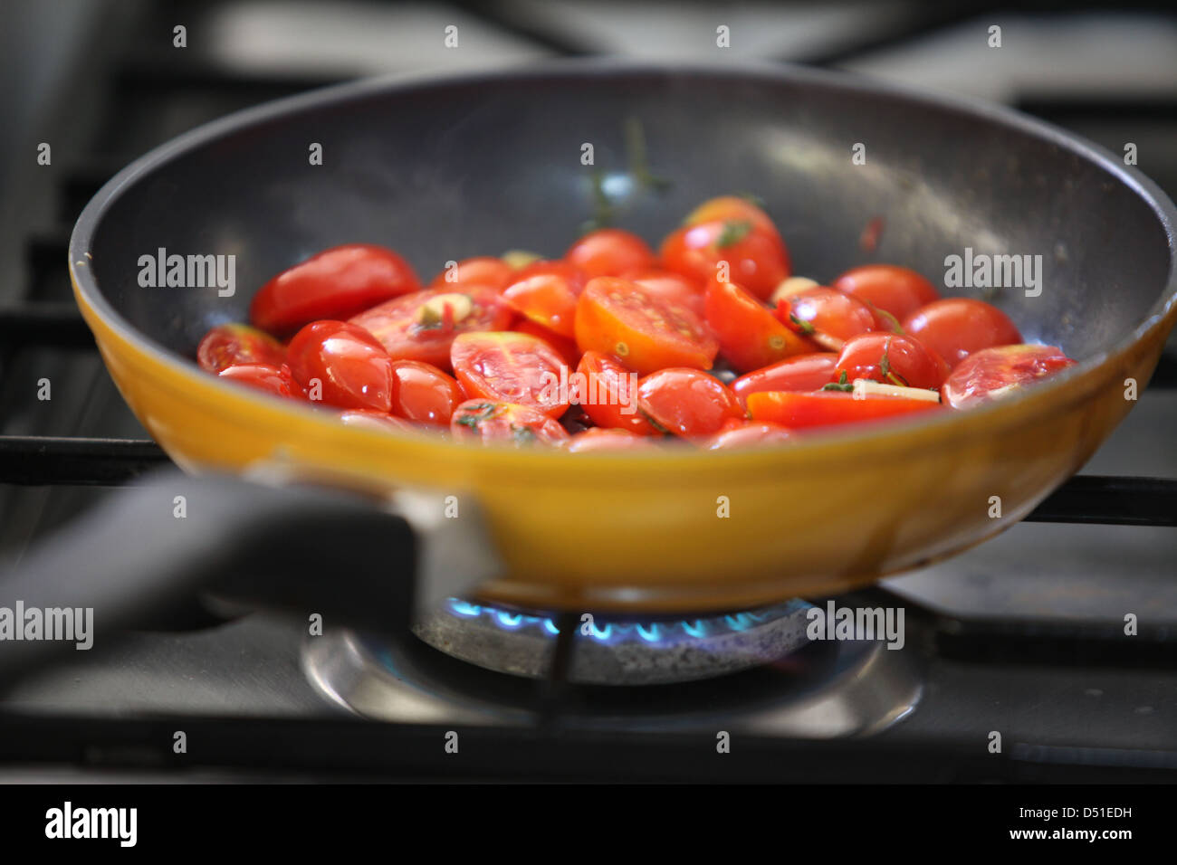 Cooking tomatoes in a frying pan Stock Photo