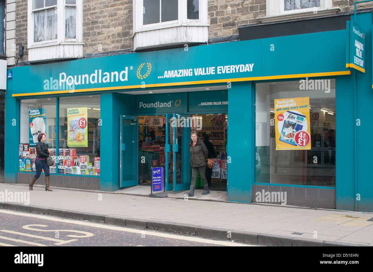 Shoppers pass Poundland store Bishop Auckland, north east England, UK Stock Photo