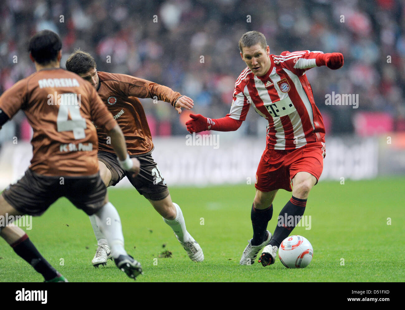 Bayern'sBastian Schweinsteiger (r) tackles Moritz Volz during a German Bundesliga match of FC Bayern Munich versus FC St. Pauli in Munich, Germany, 11 December 2010. Photo: Andreas Gebert    ATTENTION: EMBARGO CONDITIONS! The DFL permits the further utilisation of the pictures in IPTV, mobile services and other new technologies only no earlier than two hours after the end of the ma Stock Photo