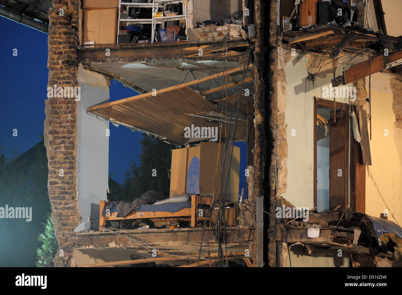 A bed room of a partly collapsed house is visible after a gas explosion