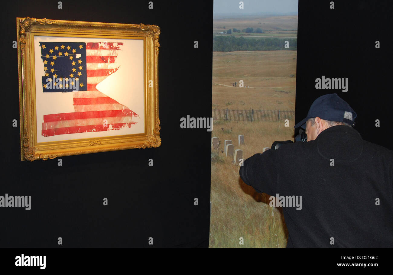 (FILE) A file picture dated 03 December 2010 shows a man filming a frame with a flag of General George Custer, who rode into the battle of Little Bighorn with the flag pictured, at Sotheby's in New York, USA. The piece of US history was sold to an unknown provate collector for 2.2 million dollars. Photo: Chris Melzer Stock Photo