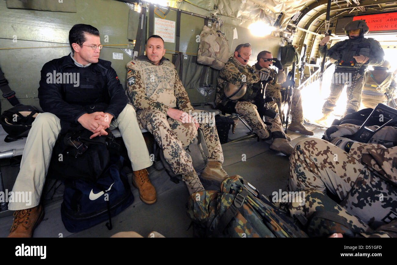 German Defence Minister Karl-Theodor zu Guttenberg (L) sits together with soldiers in a helicopter on the way to the military camp in Kunduz, Afghanistan, 13 December 2010. German Defence Minister Karl-Theodor zu Guttenberg visits the German Bundeswehr soldiers of the ISAF mission contingent in Afghanistan. Photo: MAURIZIO GAMBARINI Stock Photo