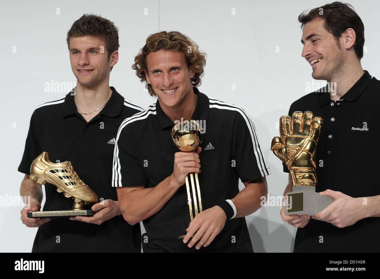 The laureates of the FIFA World Cup 2010 awards pose with their trophies (L-R) Thomas Mueller with Golden Boot for best goalgetter, Diego Forlan with Golden Ball for best player, and Iker Casillas with Golden Glove for best goalkeeper at the FIFA World Cup 2010 awards in Herzogenaurach, Germany, 14 December 2010. Apparently, Diego Forlan receives the Golden Ball, Iker Casillas the  Stock Photo