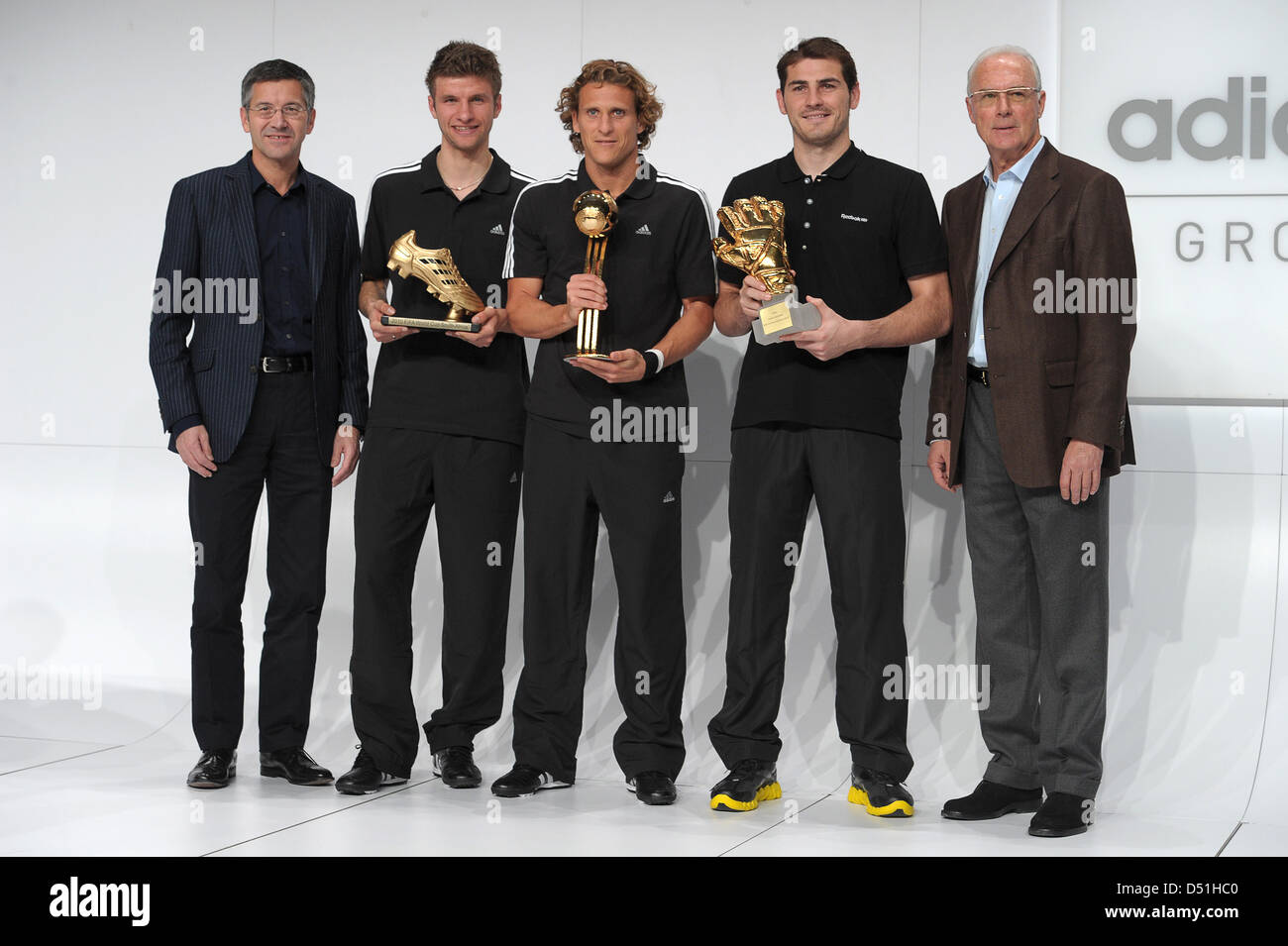 Herbert Hainer (L-R) executive chairman of the sportswear company adidas AG, German national soccer player Thomas Mueller, Uruguayan national soccer player Diego Forlan, Spanish national goalkeeper Iker Casillas and FIFA-representative Franz Beckenbauer stand next to each other during the award ceremony of the best players of the FIFA World Cup 2010 at the company headquarters of a Stock Photo
