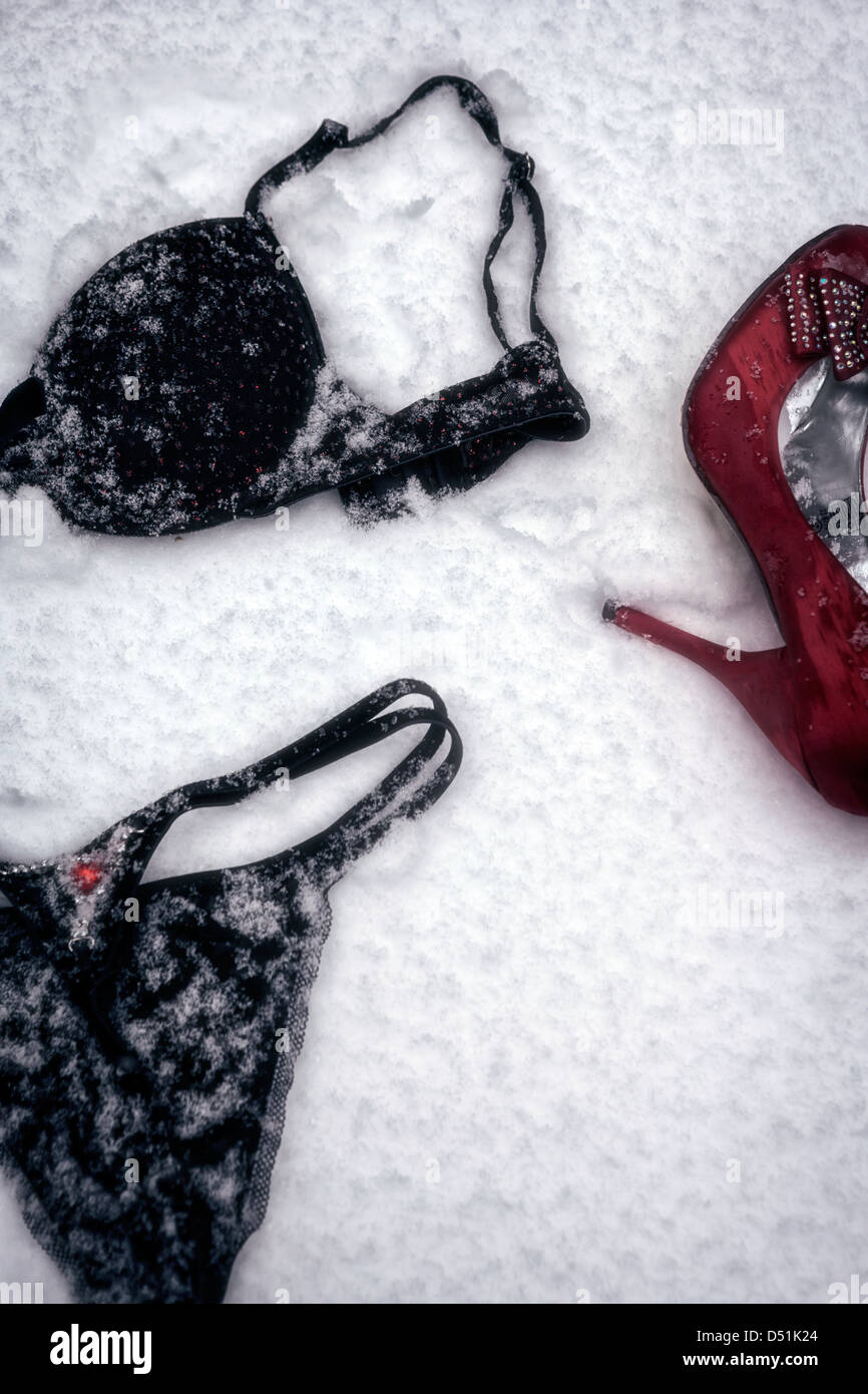 black lingerie and a red shoe lying in the snow Stock Photo - Alamy