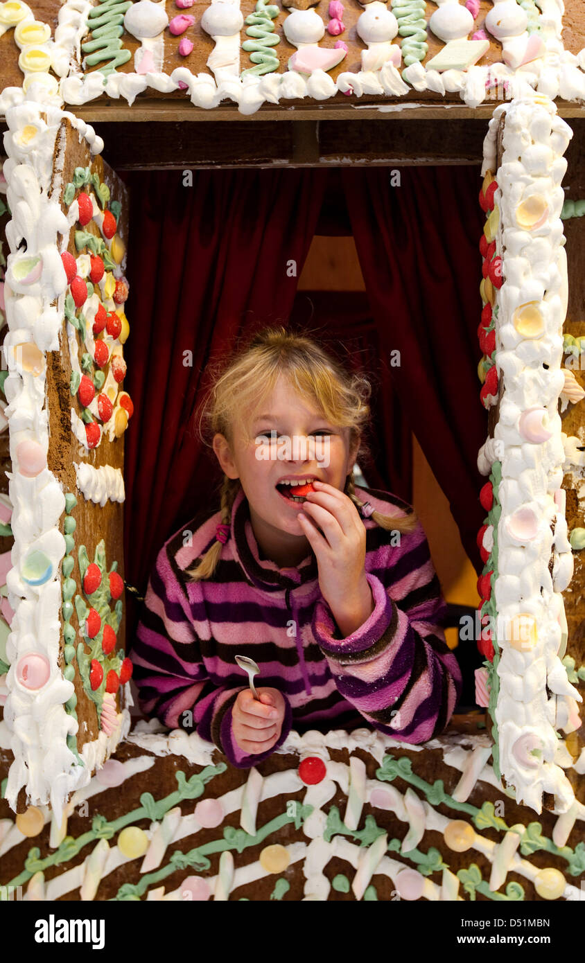 Children eating gingerbread house on hi-res stock photography and images Adult Picture