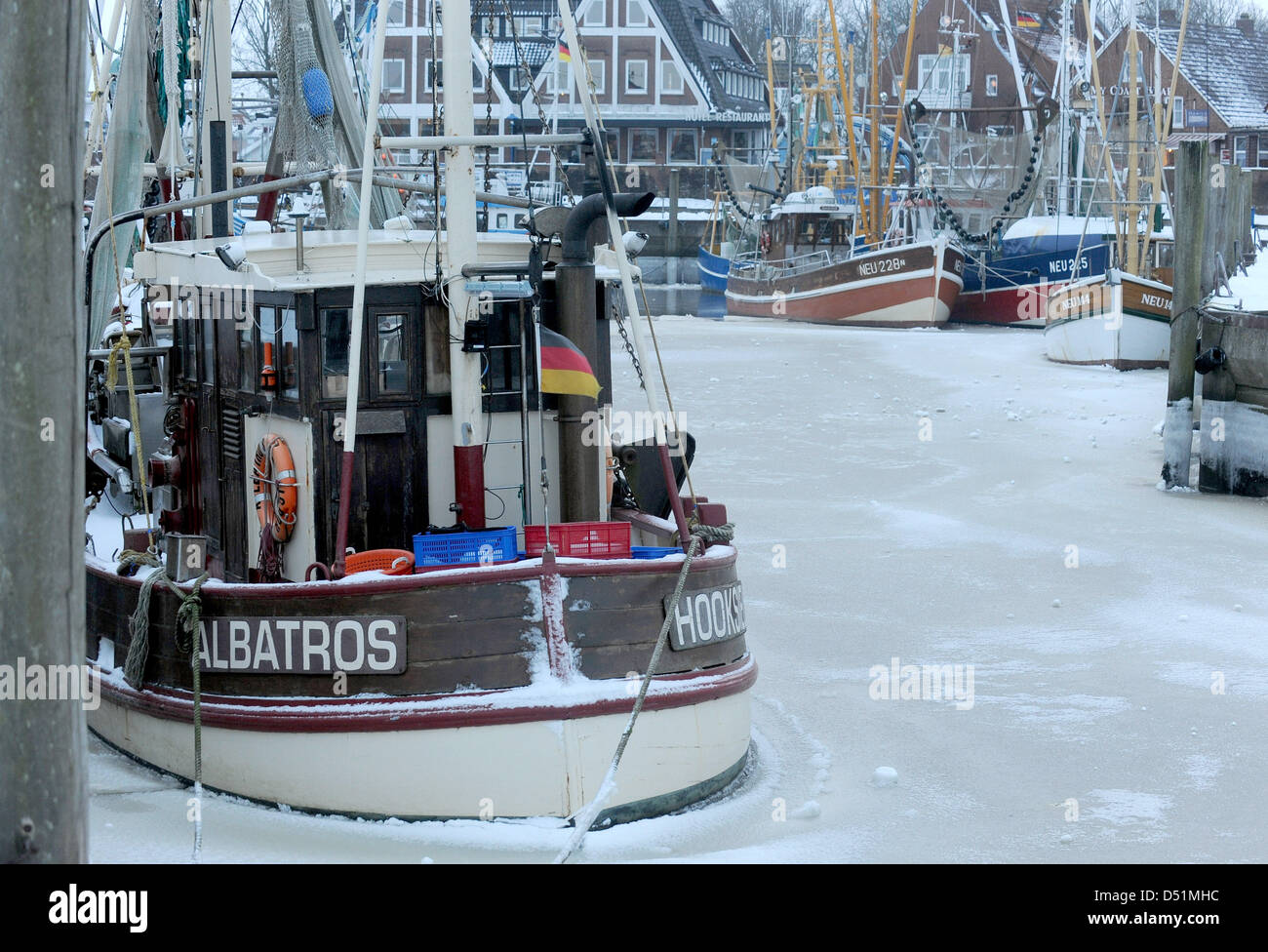 Ferries and boats are stuck in ice at the harbour in Neuharlingersiel, Germany, 28 December 2010. Ferry transport is continued in spite of ice floes in the Wadden Sea around the East Frisian Islands. Photo: Ingo Wagner Stock Photo