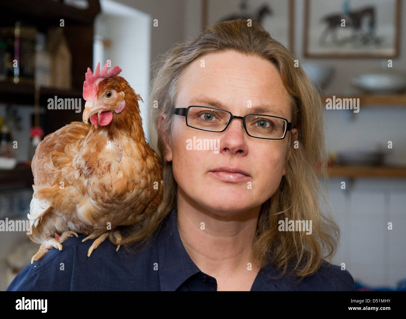 Author Karen Duve poses with chicken Rudi at her house in Ringenwalde ...