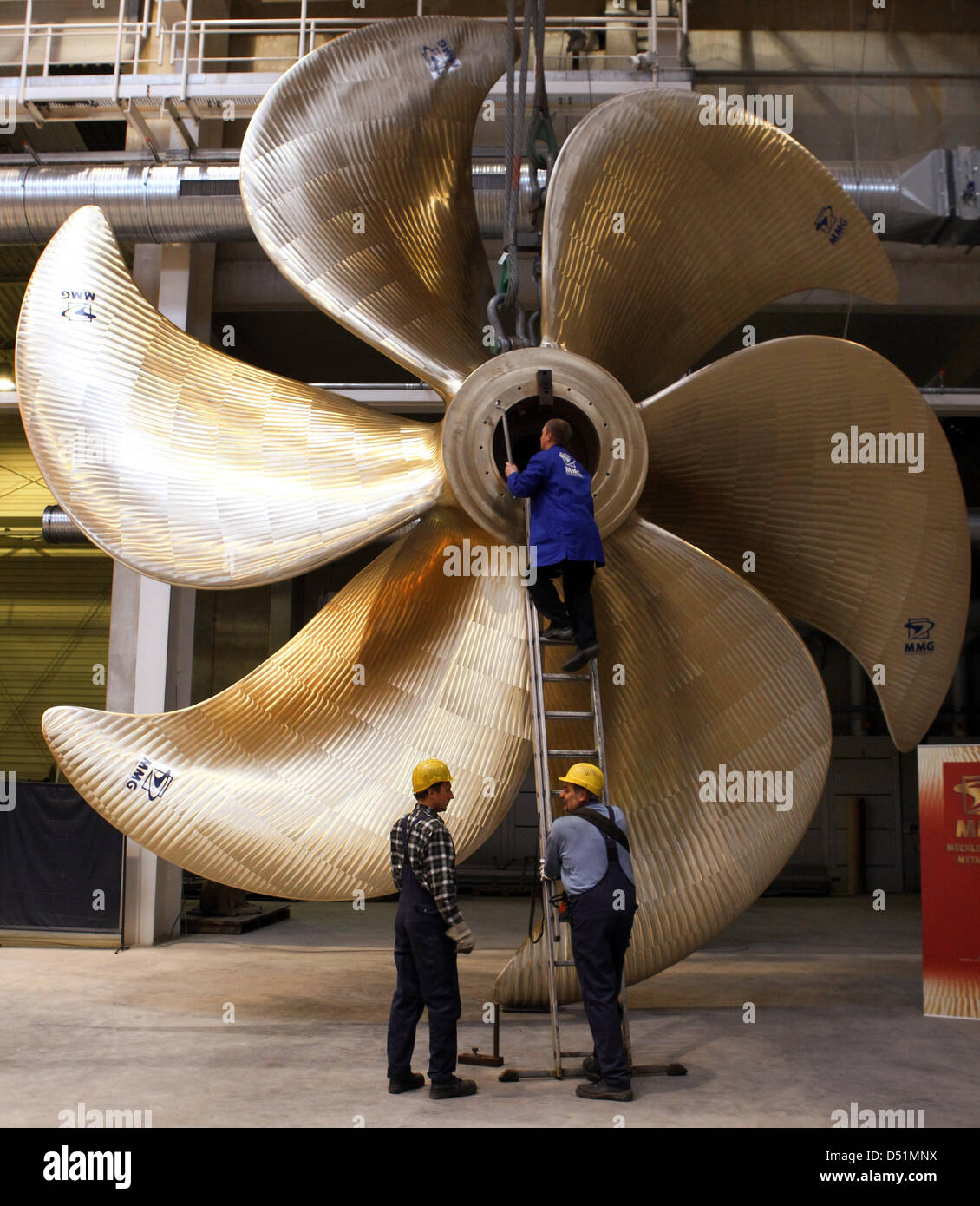 Employees work on a hundred ton heavy ship propeller at the Mecklenburg