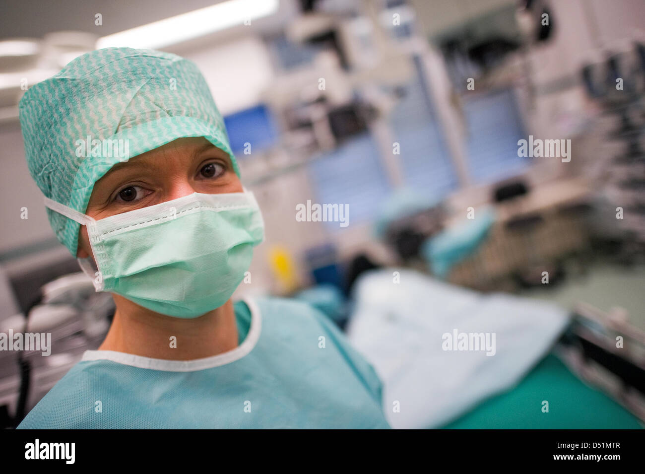 An surgery nurse stands in an operating room at the eye clinic of the