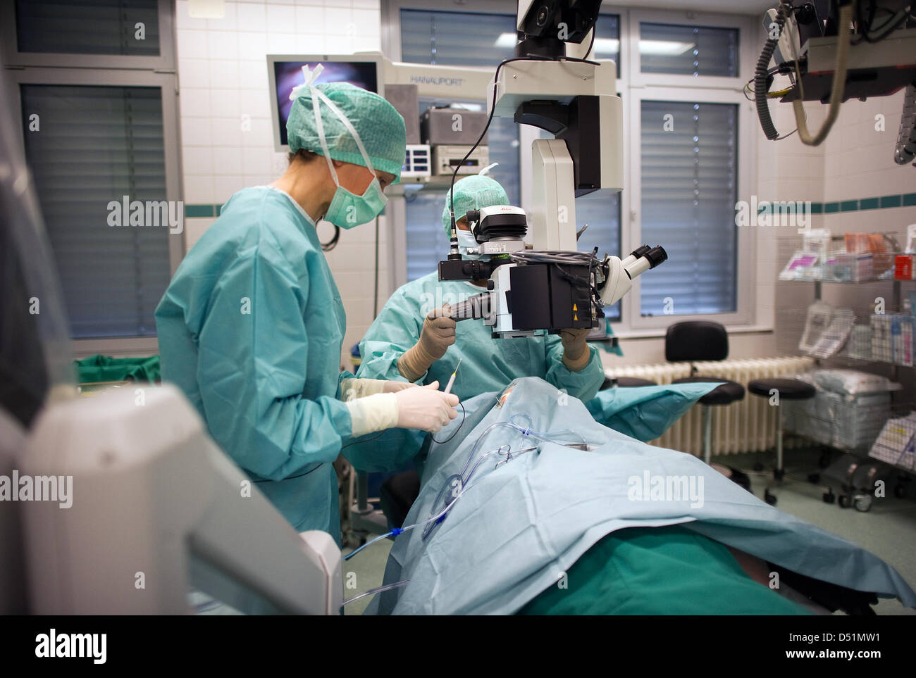 A team of physicians conduct an eye surgery for presentational purposes