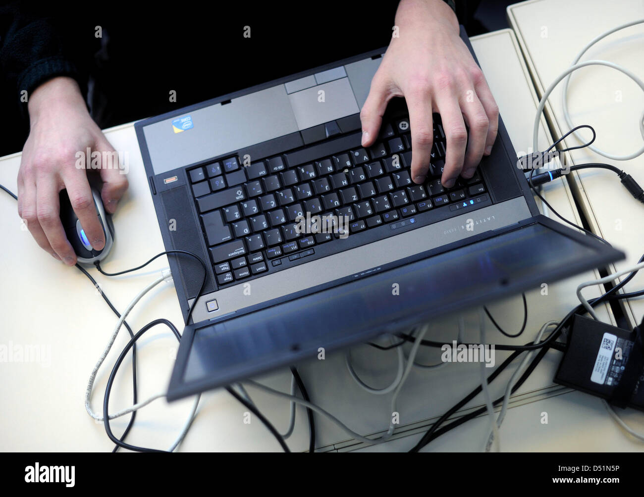 A participant works on a laptop during the 27th convention of the Chaos ...