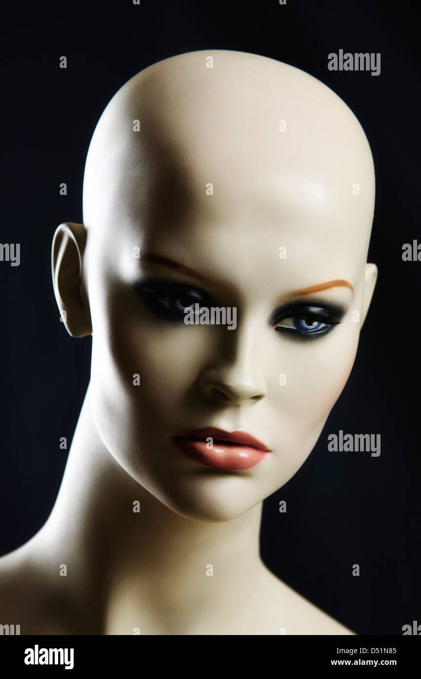 Hairless female mannequin with black background and a studio shot Rembrandt-lighting on her face. Stock Photo