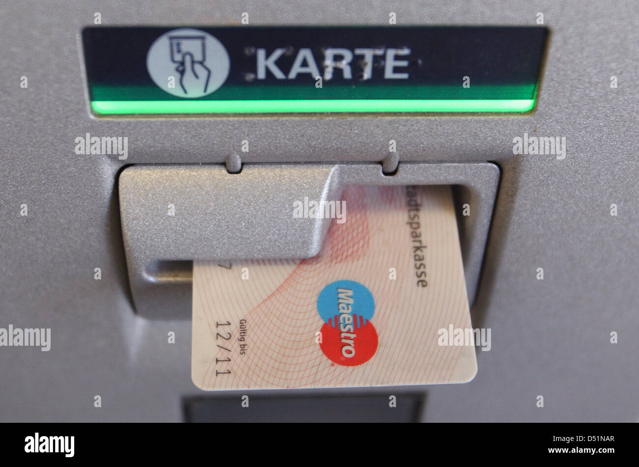 An ec card is situated in a cash machine of the bank Sparkasse in Kaufbeuren, Germany, 07 January 2010. The fee for taking money from external banks will be indicated on a display from 15 January onwards. Photo: Karl-Josef Hildenbrand Stock Photo