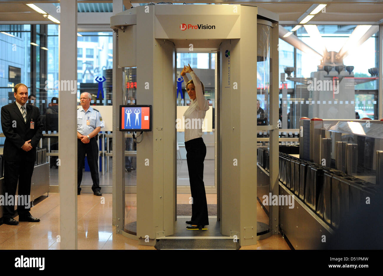 A woman walks through a body scanner at the airport in Hamburg Stock