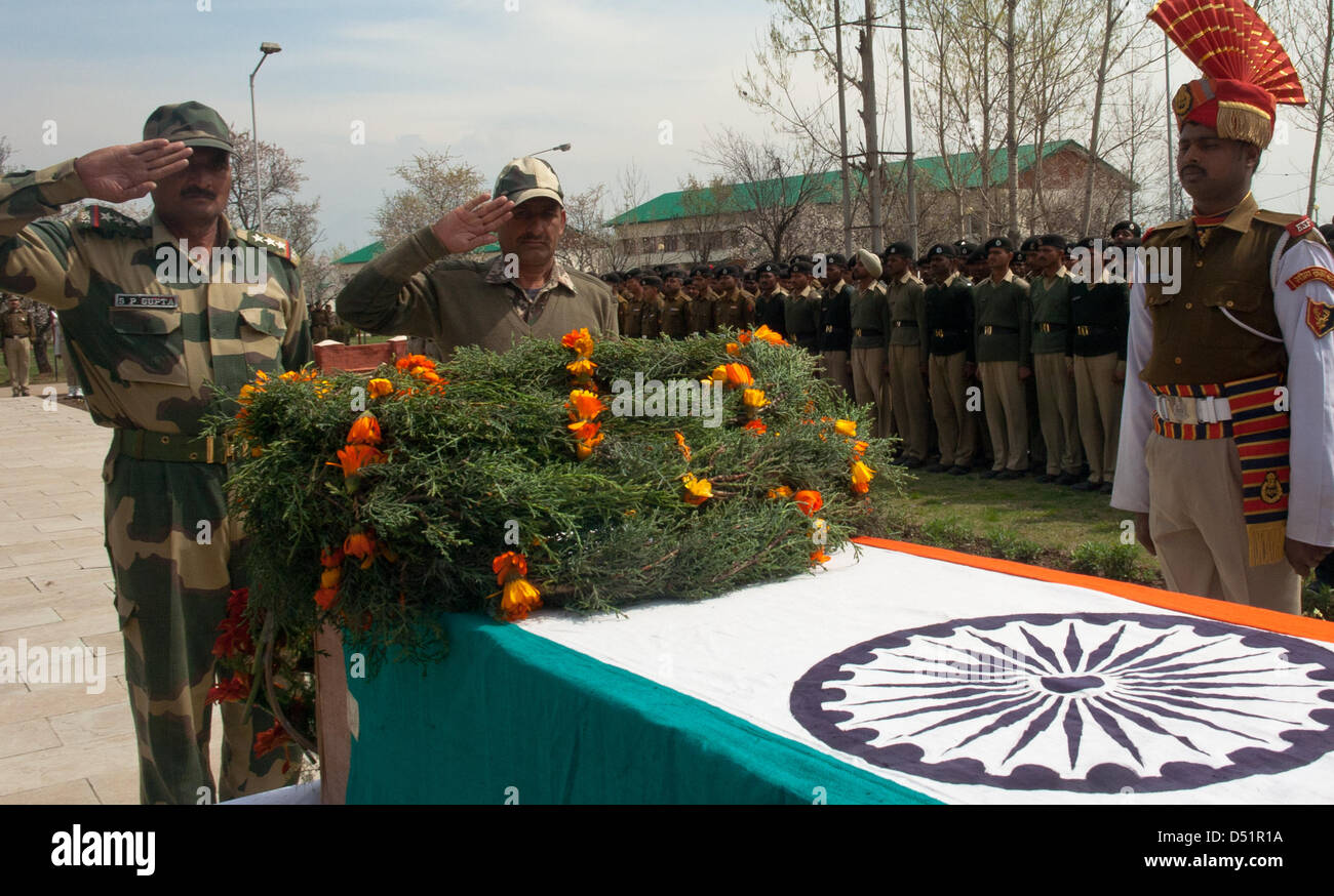 Srinagar, Indian Administered Kashmir, Saturday 22nd March 2013. Senior Indian Border Security Force officers salute the  coffin containing the body of their  killed comrade during a wreath laying ceremony in Srinagar. Suspected rebels shot dead an Indian Border Security Force (BSF) soldier and wounded two others yesterday when they ambushed their vehicle on a highway. (Photo by Sofi Suhail / Alamy) Stock Photo