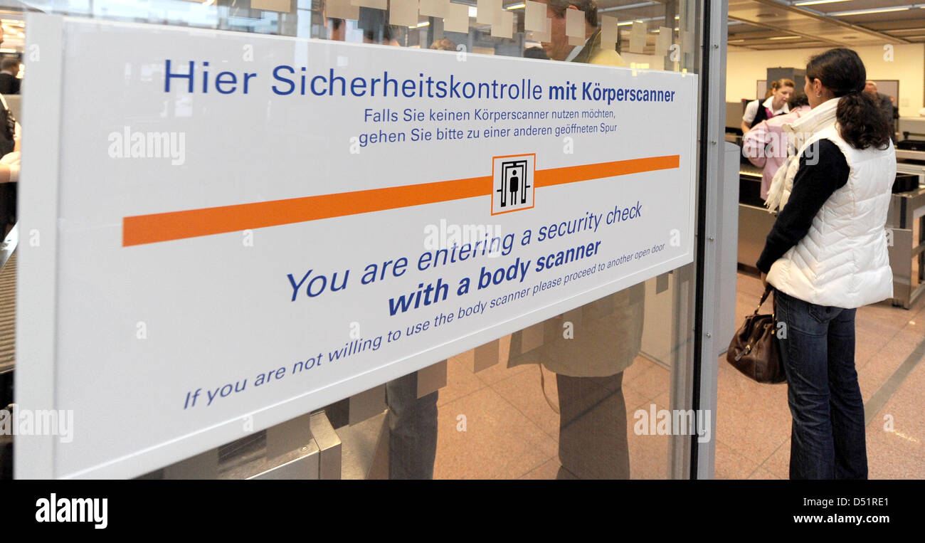 People queue at a security check with body scanners at the airport in ...