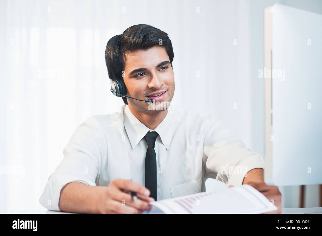 Customer service representative wearing a headset Stock Photo - Alamy