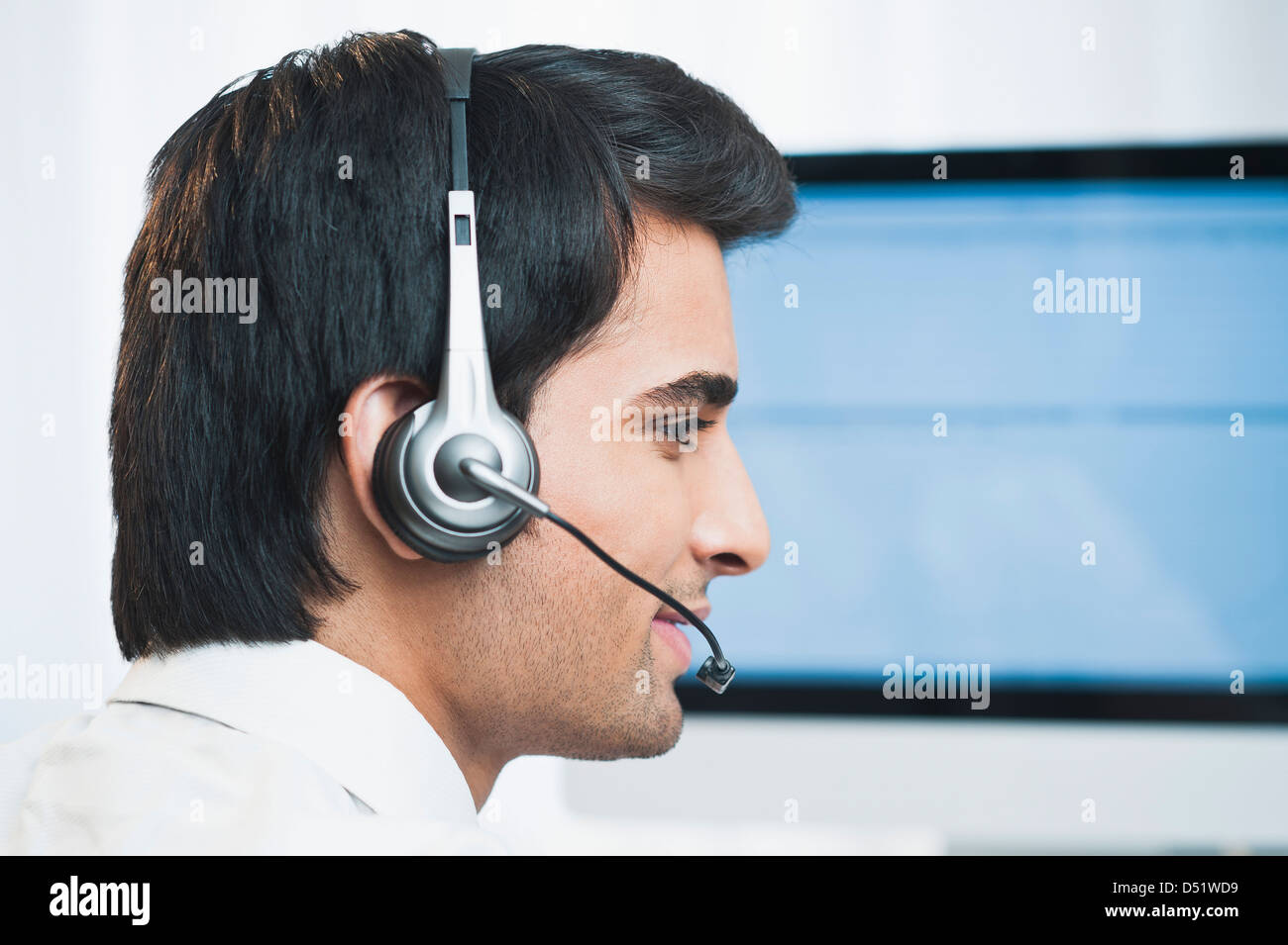Customer service representative wearing a headset Stock Photo - Alamy