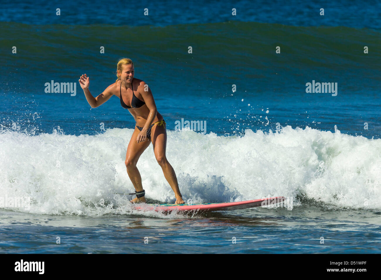 Young woman surfing longboard at Playa Guiones beach, Nosara, Nicoya  Peninsula, Guanacaste Province, Costa Rica, Central America Stock Photo -  Alamy