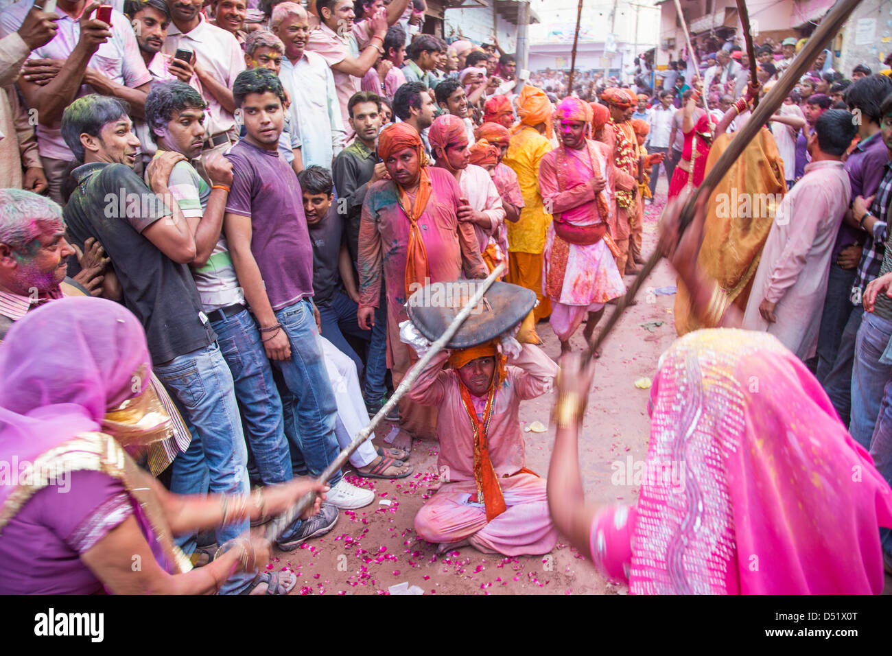 Lath mar Holi, women ritually fight off advances by men from neighboring town. Barsana, Mathura District, Uttar Pradesh, India. Stock Photo