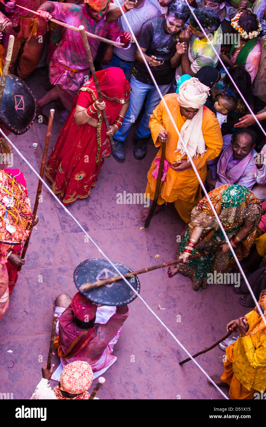 Lath mar Holi, women ritually fight off advances by men from neighboring town. Barsana, Mathura District, Uttar Pradesh, India. Stock Photo