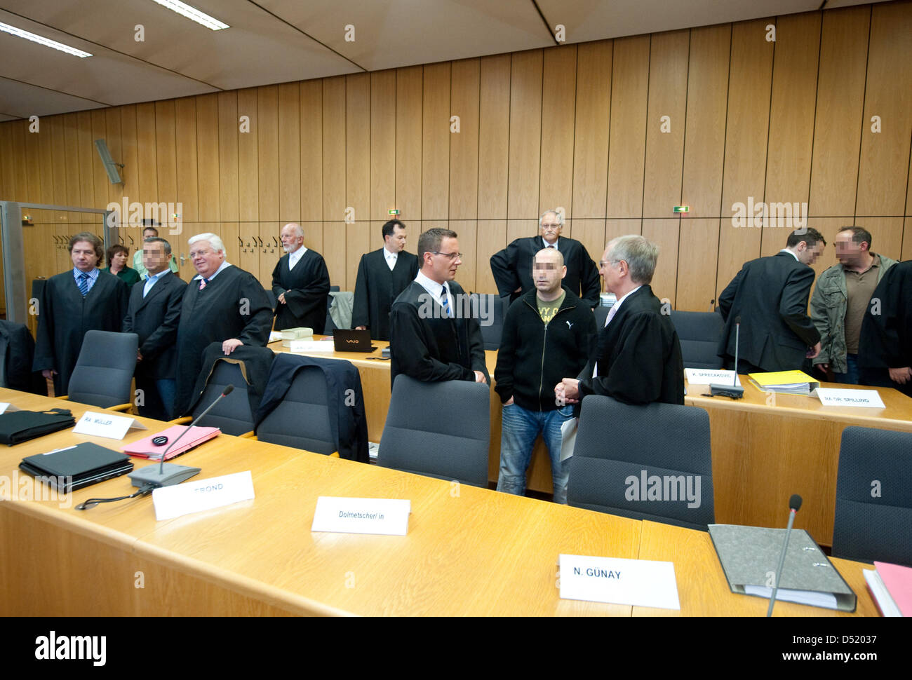 Participants involved in the match-fixing trial stand in the court room of the Regional Court in Bochum, Germany, 06 October 2010. Front row (L-R): Lawyer Reinhard Peters, defendant Tuna A., lawyers Joachim Müller and Joe Therond, defendant Nurellin G., lawyer Jens Meggers. Back row (L-R): Lawyers Fritz von Beesten, Udo Klaus Duits and Hans Geisler, defendants Kristian S. and Steva Stock Photo