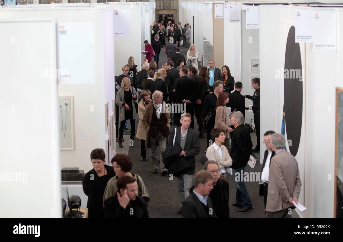 Visitors stroll around the fair Art Forum at the fairgound (Messe) in