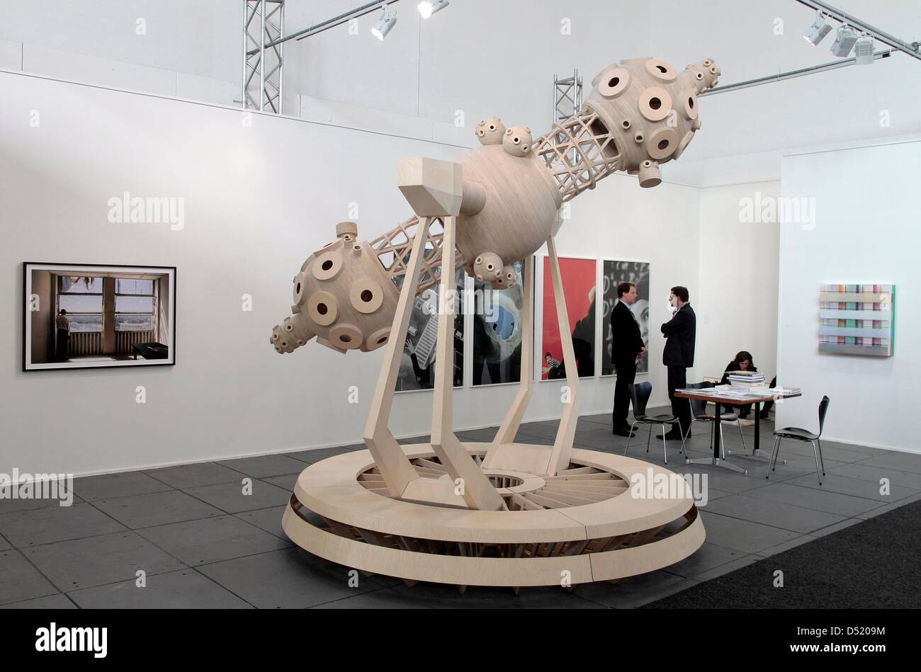Visitors stroll around the fair Art Forum at the fairgound (Messe) in
