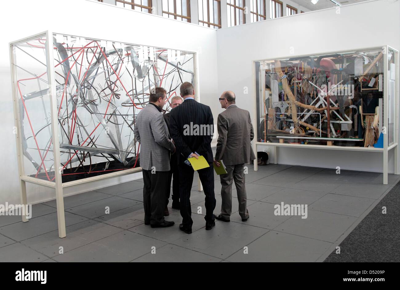 Visitors observe artworks of the fair 'Art Forum' at the fairgound