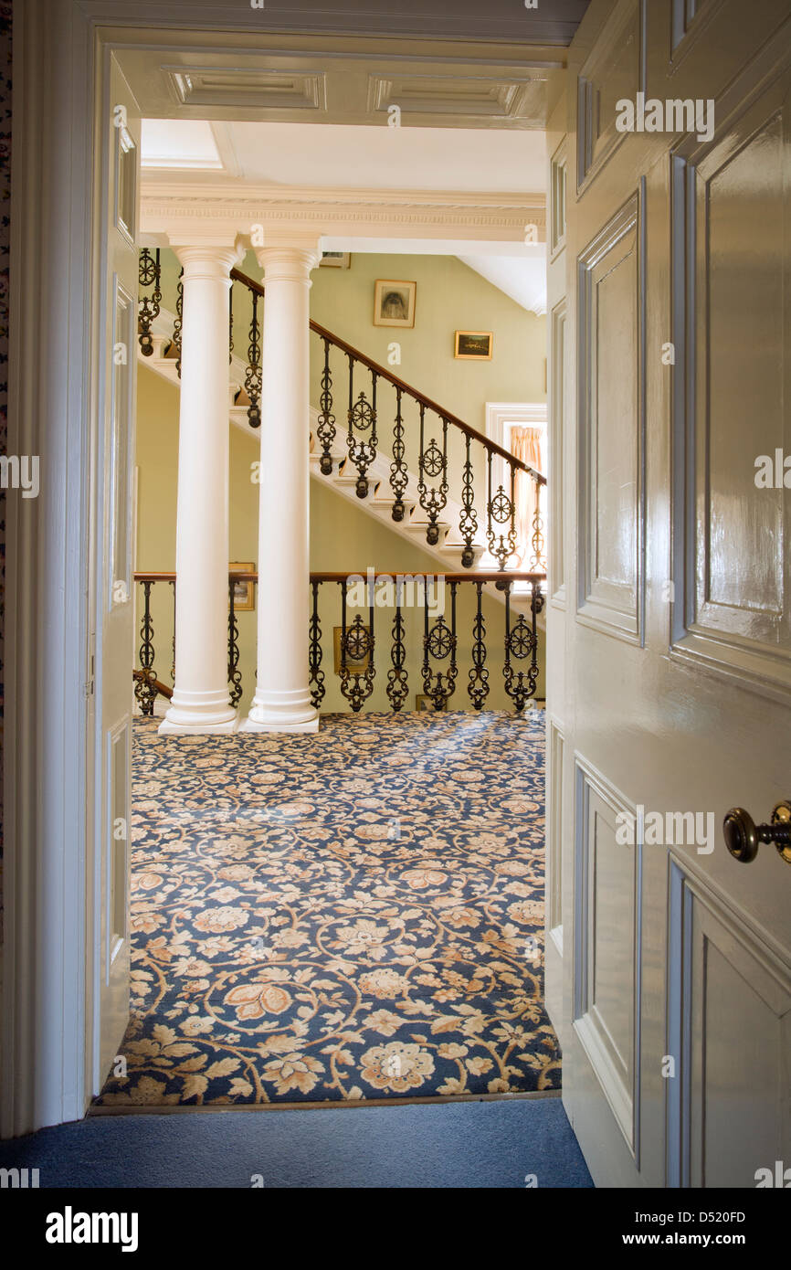 A view through a doorway to a grand period landing and stairs. Stock Photo