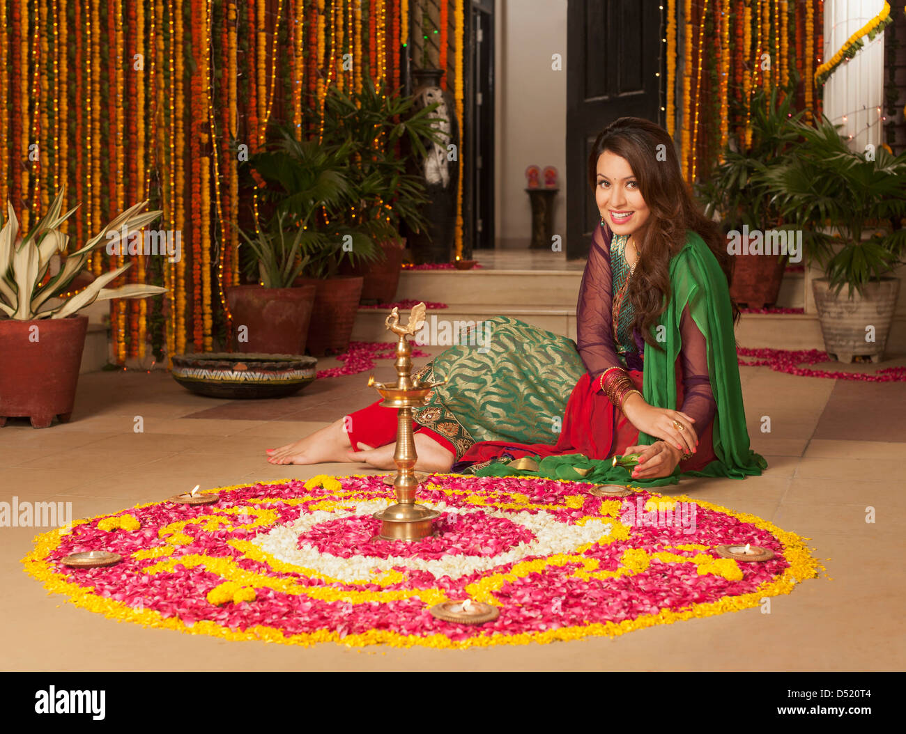 Woman decorating a rangoli on Diwali Stock Photo - Alamy