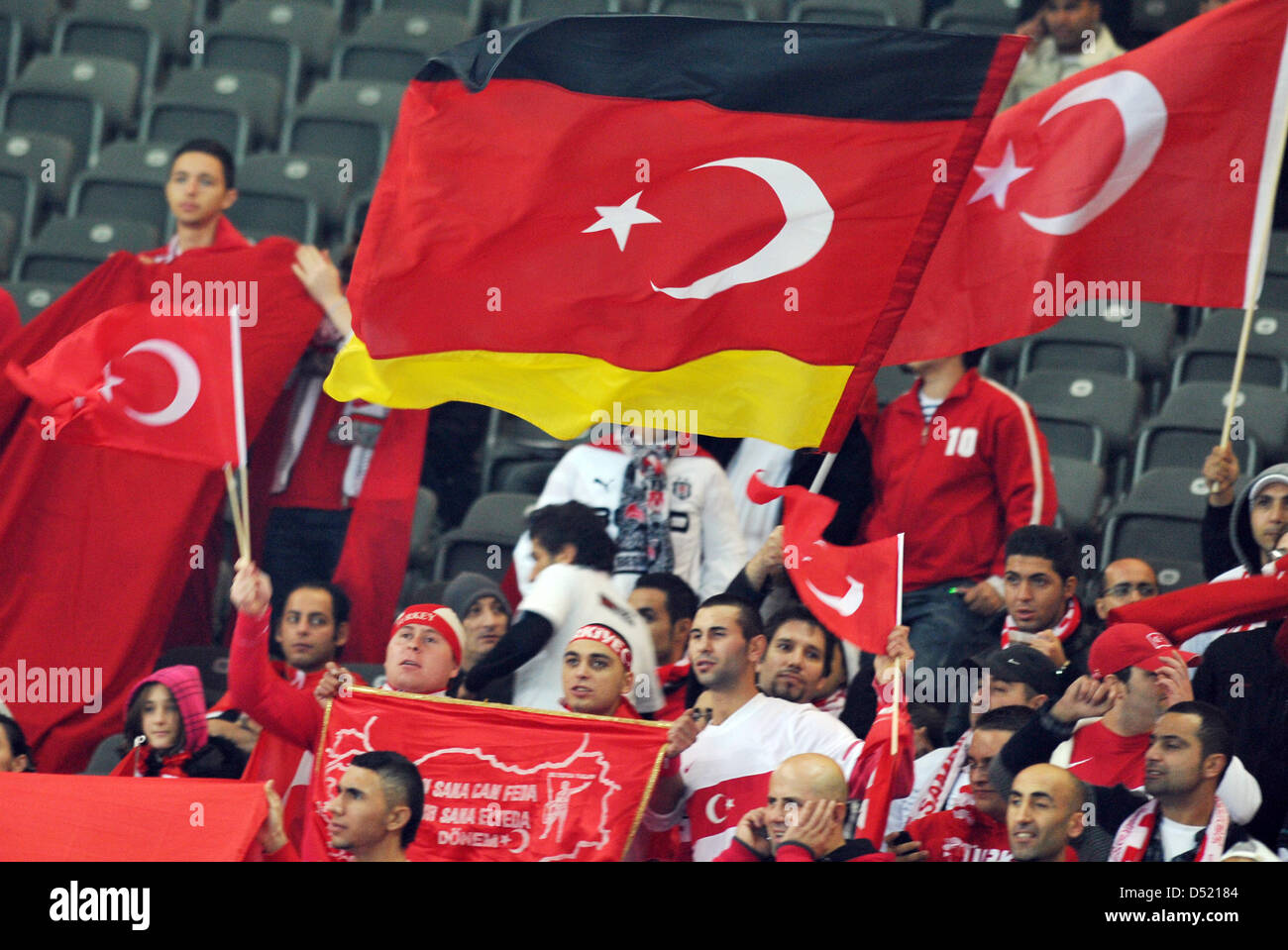 Turkish fans celebrate with a TurkishGerman flag at the Olympic Stadium in Berlin, Germany, 08