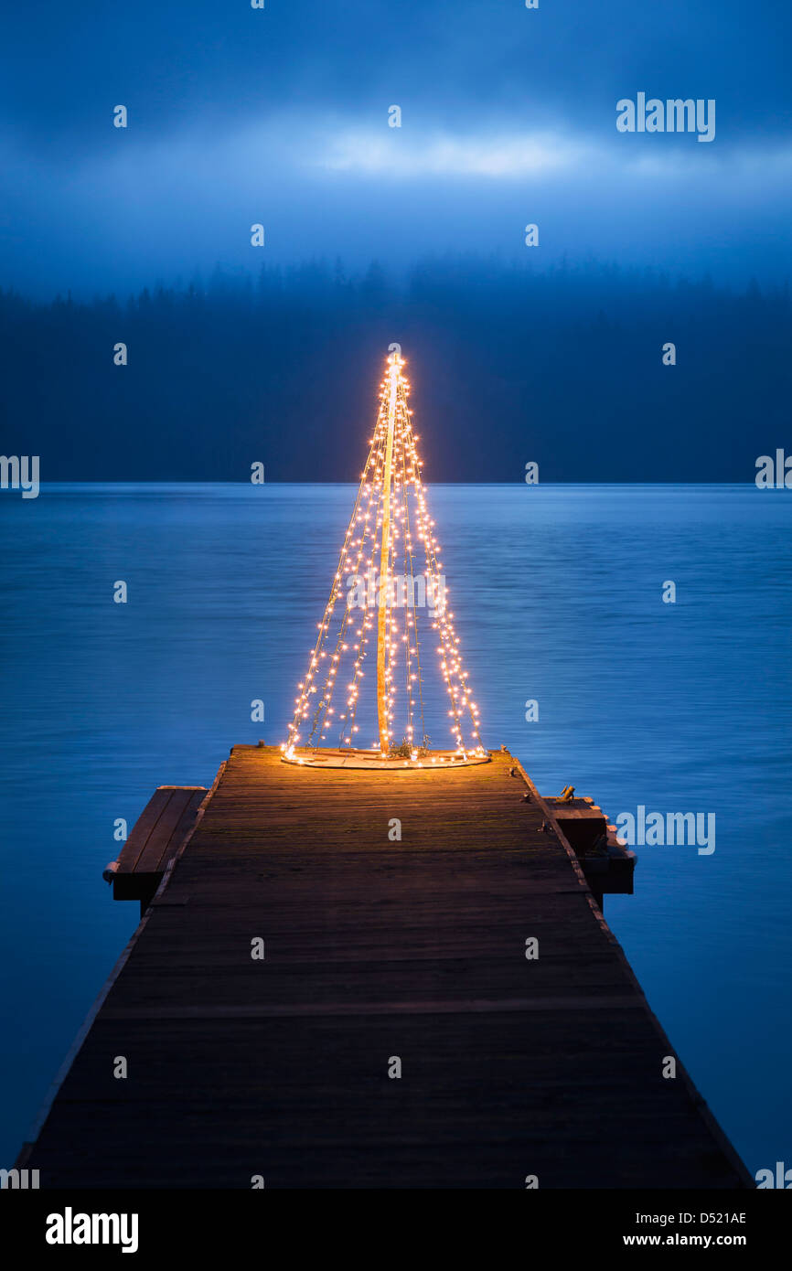 String of lights in tree shape on wooden pier Stock Photo