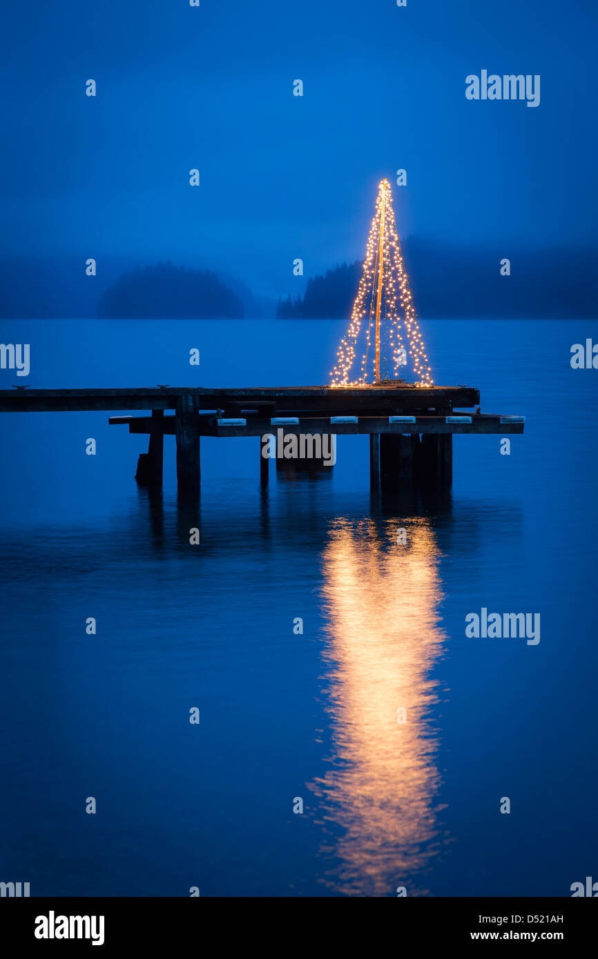 String of lights in tree shape on wooden pier Stock Photo