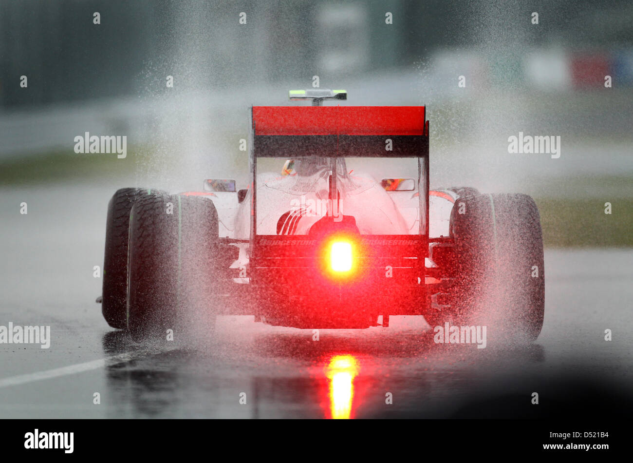 British formula one driver Lewis Hamilton of Team McLaren Mercedes pulls out of the pit lane in his racing car in heavy rainfall during the third practice session for the Japanese Grand Prix at the Suzuka Circuit in Suzuka, Japan, 09 October 2010. The 2010 Formula One Japanese Grand Prix is held on 10 October. Photo: Jens Buettner Stock Photo