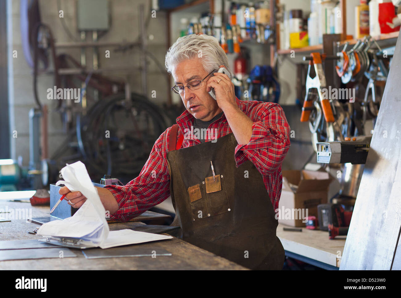 Hispanic craftsman working in shop Stock Photo