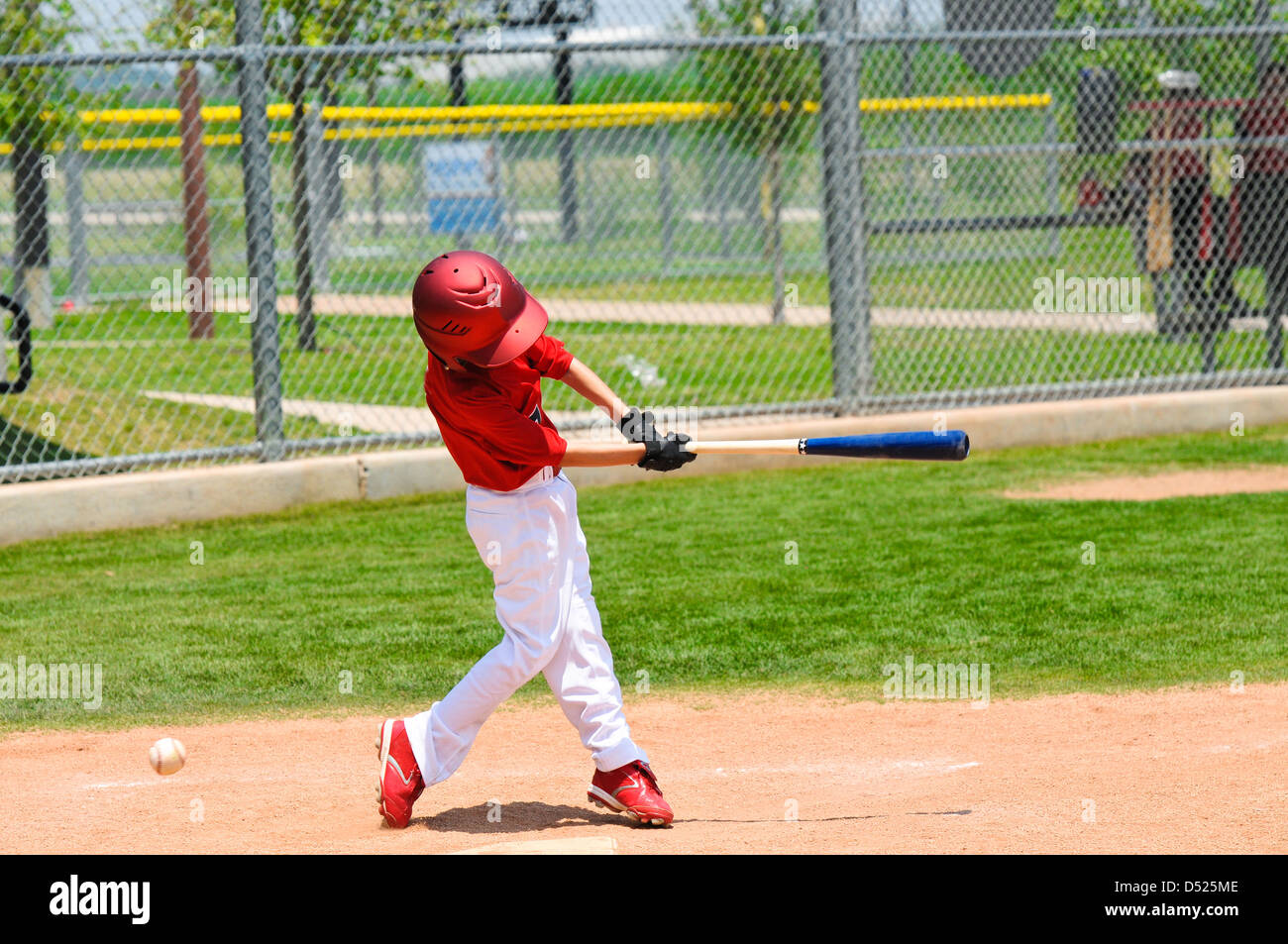 Youth baseball player swinging the bat Stock Photo Alamy