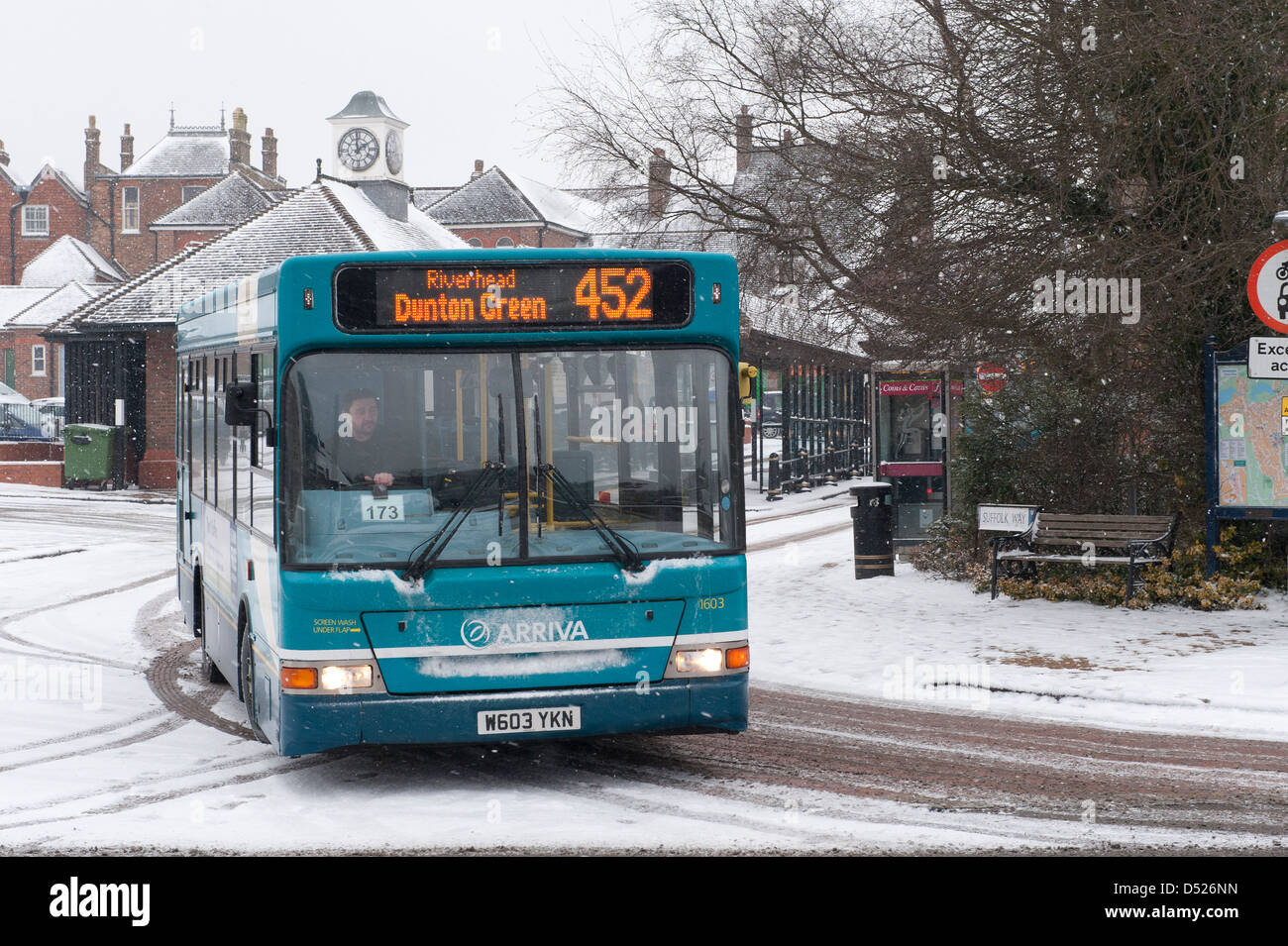 Arriva bus leaves Sevenoaks bus station during falling snow Stock Photo